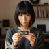 Portrait of Aiko, contributor, holding a cassette tape